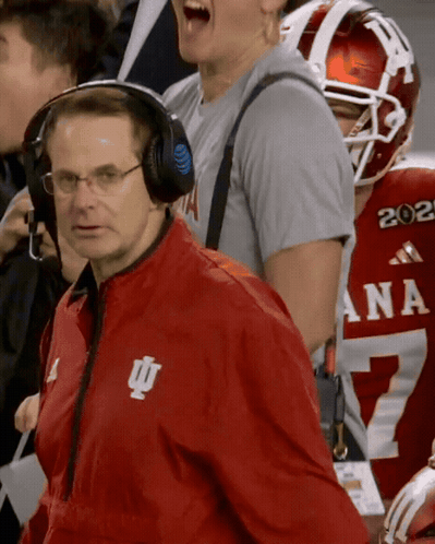 A Man Wearing Headphones And A Red Jacket With The Letters Iu On It GIF
