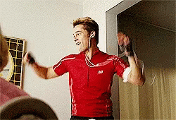 A Man Wearing Headphones And A Red Shirt With The Letter S On The Front GIF