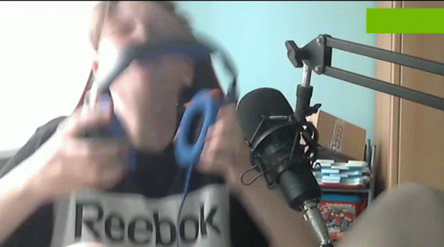 A Man Wearing Headphones And A Reebok Shirt GIF