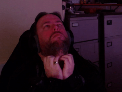 A Man Wearing Headphones And A Ring On His Finger GIF