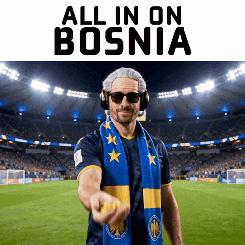 a man wearing headphones and a scarf stands in front of a soccer field with the words all in on bosnia above him