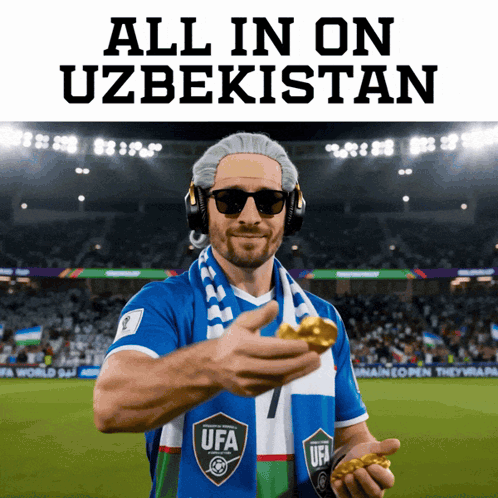 A Man Wearing Headphones And A Scarf With The Word Ufa On It Holds A Gold Medal GIF