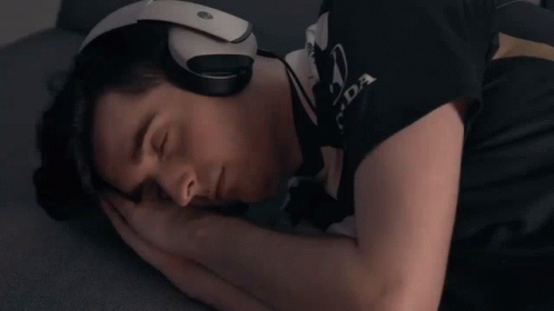 A Man Wearing Headphones And A Shirt That Says Honda Is Sleeping GIF