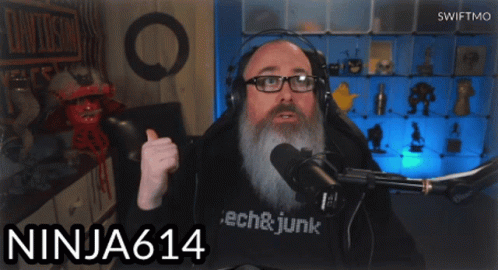 A Man Wearing Headphones And A Shirt That Says Tech & Junk GIF