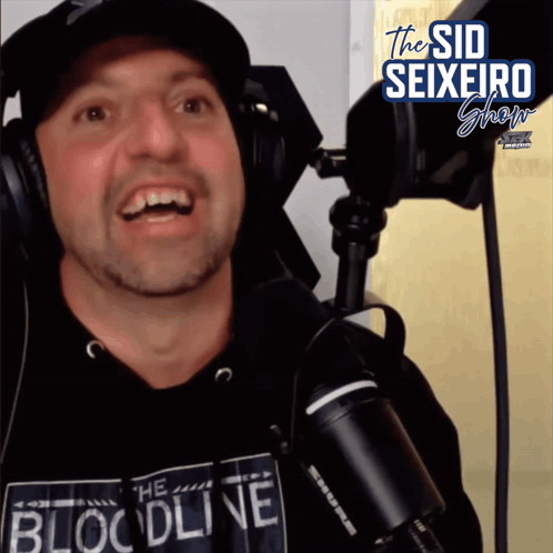 A Man Wearing Headphones And A Shirt That Says The Bloodline GIF