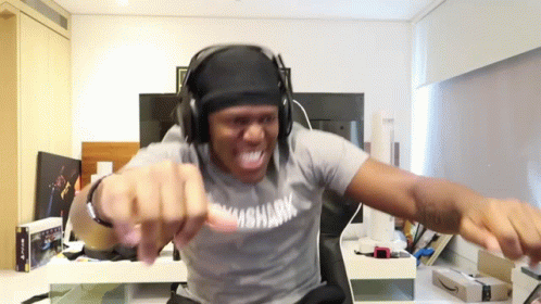 A Man Wearing Headphones And A Shirt Which Says Shark On It GIF