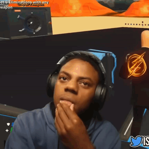 A Man Wearing Headphones And A Shirt With A Lightning Bolt On It Is Playing A Video Game GIF