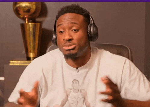 A Man Wearing Headphones And A Shirt With A Picture Of A Basketball Player With The Number 33 GIF