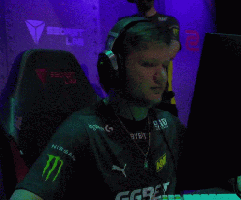 A Man Wearing Headphones And A Shirt With Logitech On It GIF