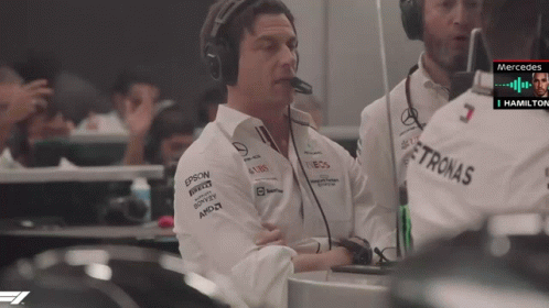 A Man Wearing Headphones And A Shirt With Petronas On It GIF