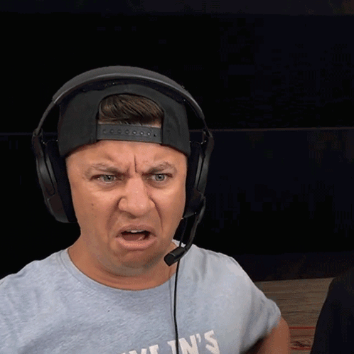 A Man Wearing Headphones And A T-Shirt That Says Kylin 'S Making A Funny Face GIF