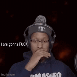 A Man Wearing Headphones And A Thrasher Hoodie Is Sticking Out His Tongue . GIF