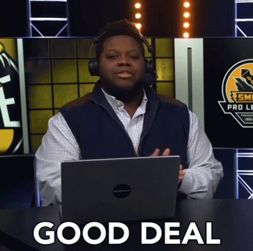 A Man Wearing Headphones And A Vest Is Sitting In Front Of A Laptop With The Words Good Deal Written On It GIF
