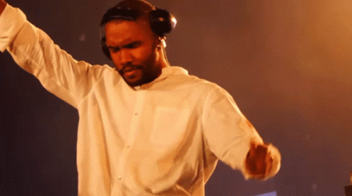 A Man Wearing Headphones And A White Shirt Dancing GIF