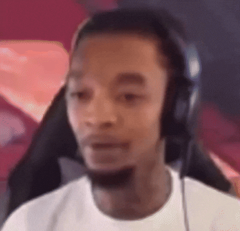 a man wearing headphones and a white shirt is looking at the camera .