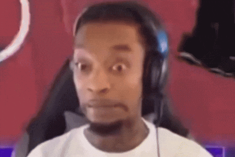 A Man Wearing Headphones And A White Shirt Is Making A Funny Face . GIF