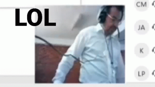 A Man Wearing Headphones And A White Shirt Is Standing In Front Of A Screen With The Words Lol On It . GIF