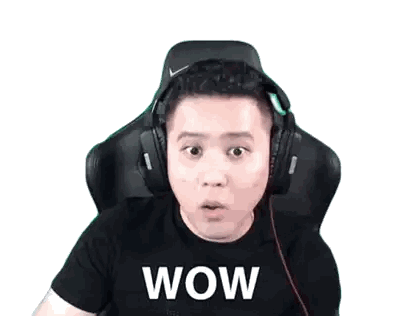 a man wearing headphones and a wow shirt is making a surprised face
