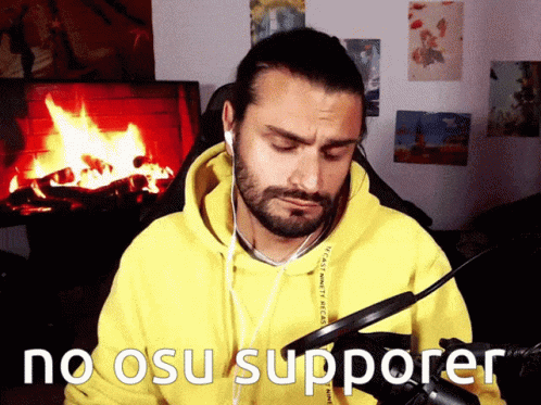 A Man Wearing Headphones And A Yellow Hoodie Says No Osu Supporter In Front Of A Fireplace GIF
