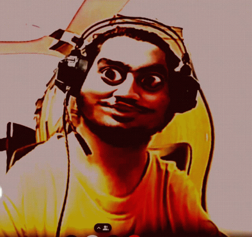 A Man Wearing Headphones And A Yellow Shirt Is Looking At Something GIF