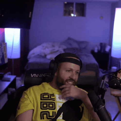 A Man Wearing Headphones And A Yellow Shirt That Says Abc GIF