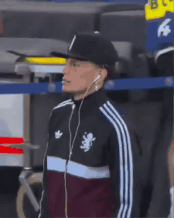 a man wearing headphones and an adidas jacket with a lion on the front