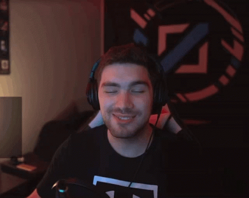 A Man Wearing Headphones And An Under Armour Shirt GIF