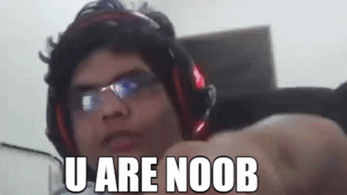 A Man Wearing Headphones And Glasses Is Pointing At The Camera With The Words `` U Are Noob '' Written On His Face . GIF