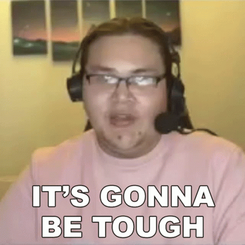 A Man Wearing Headphones And Glasses Is Sitting In Front Of A Computer Screen . GIF