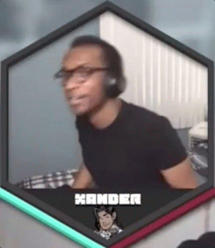 A Man Wearing Headphones And Glasses Is Sitting In Front Of A Computer Screen . GIF