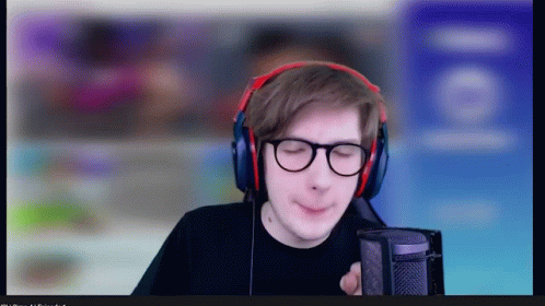 A Man Wearing Headphones And Glasses Looks At The Camera GIF