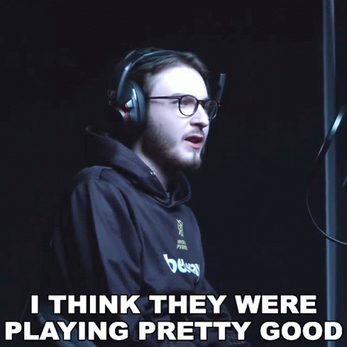 a man wearing headphones and glasses says " i think they were playing pretty good " in a dark room