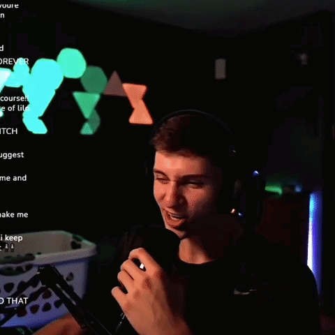 A Man Wearing Headphones And Holding A Microphone In Front Of A Screen That Says " Yt " GIF