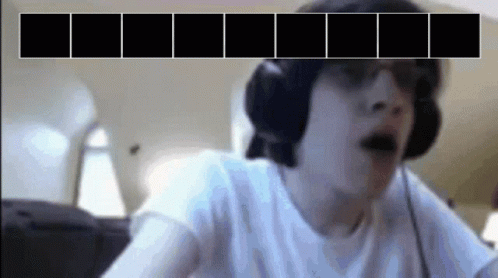A Man Wearing Headphones And Sunglasses Is Looking At A Screen With Black Squares On It GIF