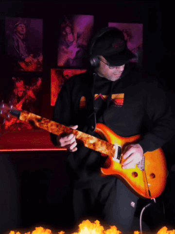 a man wearing headphones and sunglasses is playing an electric guitar