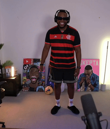 A Man Wearing Headphones And Sunglasses Stands In Front Of A Pink Sign That Says ' Kepta ' GIF