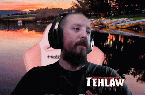A Man Wearing Headphones Has Tehlaw Written On His T-Shirt GIF