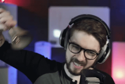 A Man Wearing Headphones Holds A Trumpet In His Hand GIF