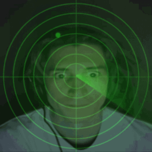 A Man Wearing Headphones Is Being Monitored By A Green Radar Screen GIF