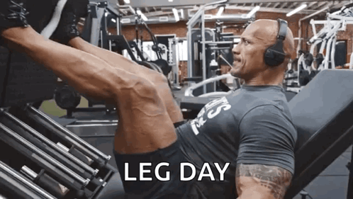 A Man Wearing Headphones Is Doing Leg Day GIF