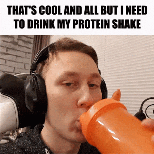 A Man Wearing Headphones Is Drinking From An Orange Bottle GIF