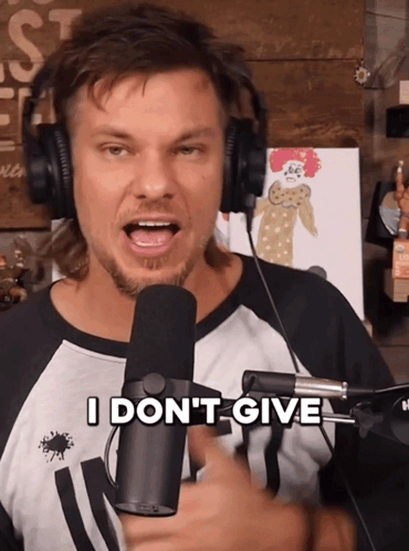A Man Wearing Headphones Is Holding A Microphone And Says I Don 'T Give GIF