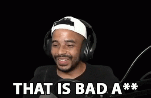 a man wearing headphones is laughing in front of a microphone and says `` that is bad a ** '' .