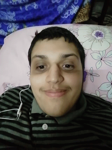a man wearing headphones is laying on a bed