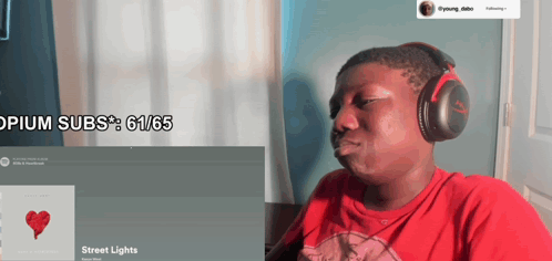 a man wearing headphones is looking at a screen that says ' opium subs ' on it