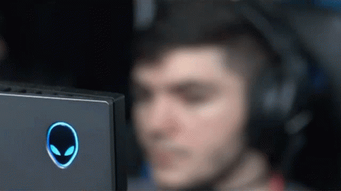 A Man Wearing Headphones Is Looking At An Alien Logo GIF