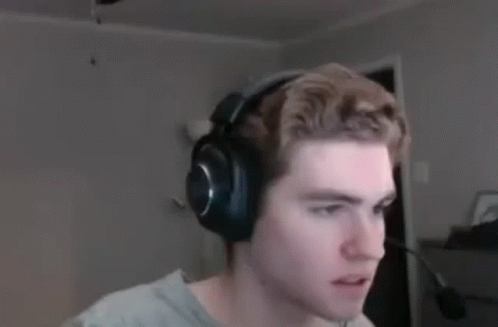 A Man Wearing Headphones Is Looking At The Camera In A Blurry Photo . GIF