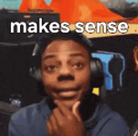 A Man Wearing Headphones Is Making A Funny Face And The Words `` Makes Sense '' Are Above Him . GIF