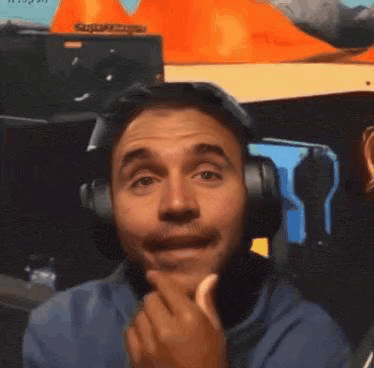 A Man Wearing Headphones Is Making A Funny Face While Eating A Banana . GIF