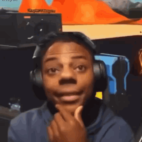 A Man Wearing Headphones Is Making A Funny Face While Looking At The Camera . GIF